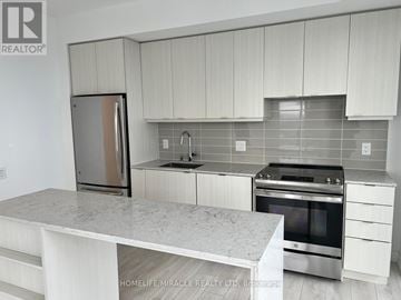Mississauga (City Centre) condo for rent - A kitchen with white cabinets and a marble countertop.