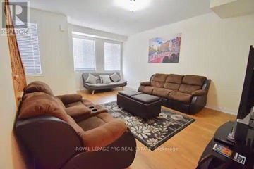 Brampton (Heart Lake East) townhouse for rent - A living room with a brown couch and a television.