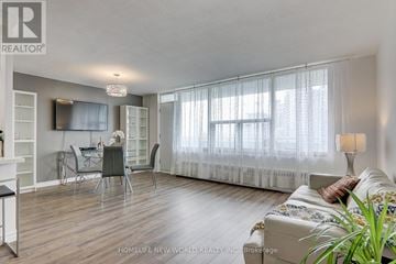 Toronto (Henry Farm) condo for rent - A living room with a dining table and chairs, a couch, and a television.