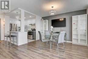 Toronto (Henry Farm) condo for rent - A modern kitchen with a bar area and a television mounted on the wall.