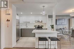 Toronto (Henry Farm) condo for rent - A modern kitchen with white cabinets and a large island.