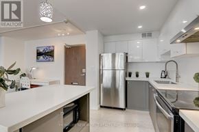 Toronto (Henry Farm) condo for rent - A modern kitchen with a refrigerator, sink, and cabinets.
