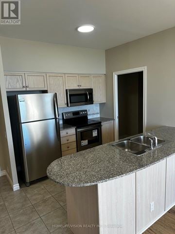 Toronto (Victoria Village) condo for rent - A kitchen with a granite countertop and stainless steel appliances.