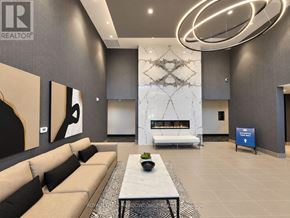Milton (Walker) condo for rent - A modern living room with a large sofa and a coffee table.