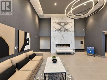 Milton (Walker) condo for rent - A modern living room with a large sofa and a coffee table.