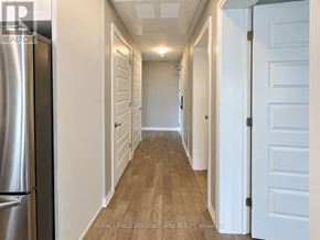 Milton (Walker) condo for rent - A long hallway with white doors and a wooden floor.