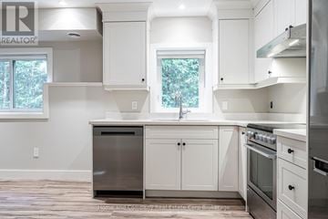 St. Marys apartment for rent - A white kitchen with a black dishwasher and stove.