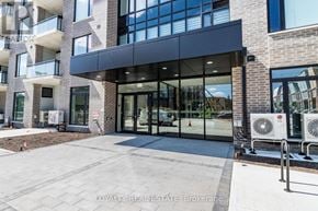 Waterloo condo for rent - A modern building entrance with glass doors and a brick facade.