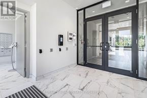 Waterloo condo for rent - A white marble floor with a black door and a black handle.
