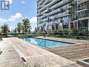 Toronto (Waterfront Communities) condo for rent - A large wooden deck with a pool in the middle of it.