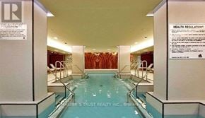 Toronto (Waterfront Communities) condo for rent - A pool in a building with a sign that says "Master's Trust Realty Inc., Brokerage".