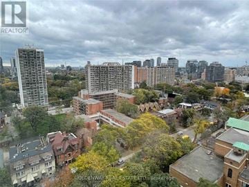 Toronto (Church-Yonge Corridor) condo for rent - A real estate company logo is displayed on an aerial view of a cityscape.