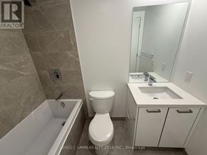 Toronto (Moss Park) condo for rent - A bathroom with a toilet, sink, and bathtub.