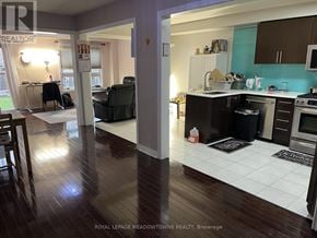 Milton (Cl Clarke) townhouse for rent - A kitchen and living room with wooden floors and white tiled flooring in the kitchen.