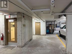 Ottawa condo for rent - A parking garage with a car parked on the right side.