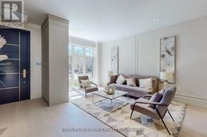 Toronto (Leaside) apartment for rent - A living room with a grey couch, a glass coffee table, and a large painting on the wall.