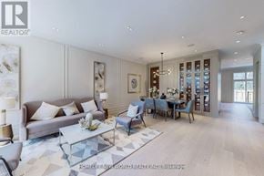 Toronto (Leaside) apartment for rent - A spacious living room with a grey sofa, a glass coffee table, and a dining table set up with chairs.