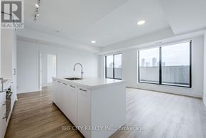 Toronto (Thorncliffe Park) condo for rent - A spacious kitchen with white cabinets and a large island.