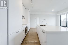 Toronto (Thorncliffe Park) condo for rent - A white kitchen with a sink and a window.