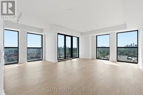 Toronto (Thorncliffe Park) condo for rent - A large empty room with a view of the city.