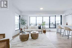 Toronto (Thorncliffe Park) condo for rent - A living room with a white couch, a coffee table, and a rug.