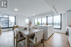 Toronto (Thorncliffe Park) condo for rent - A modern kitchen and dining area with wooden floors and white walls.