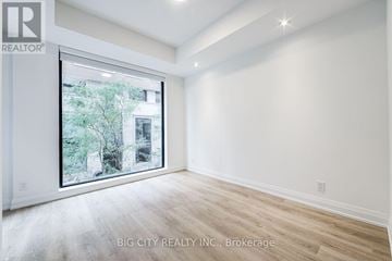 Toronto (Thorncliffe Park) condo for rent - A room with a large window and wooden flooring is on the market with Big City Realty Inc.