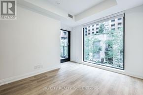 Toronto (Thorncliffe Park) condo for rent - A room with a large window overlooking a cityscape.