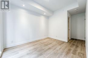 Toronto (Thorncliffe Park) condo for rent - A spacious room with wooden flooring and white walls.