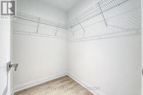 Toronto (Thorncliffe Park) condo for rent - A white wall with a metal shelf attached to it.