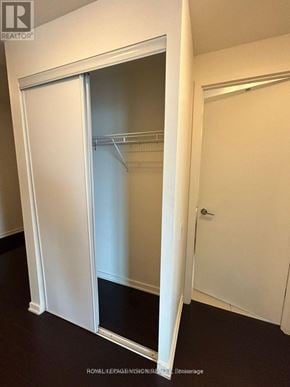 Toronto (South Parkdale) condo for rent - A white sliding door in a room with a black floor.