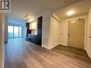 Toronto (Waterfront Communities) condo for rent - A spacious room with wood flooring and a large window.