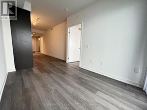 Toronto (Waterfront Communities) condo for rent - A spacious room with wood flooring and white walls.