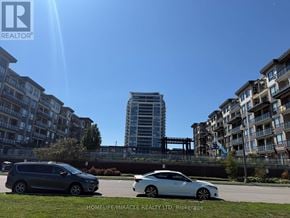 Grimsby (Grimsby Beach) condo for rent - Two cars are parked in a lot with apartment buildings in the background.