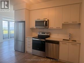 Grimsby (Grimsby Beach) condo for rent - A kitchen with white cabinets and stainless steel appliances.