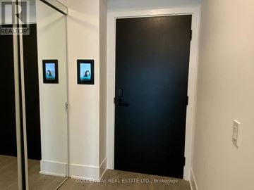 Toronto (Waterfront Communities) condo for rent - A black door is in a white hallway.