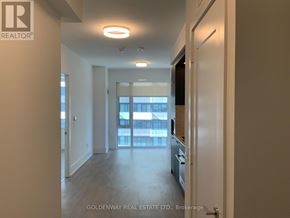 Toronto (Waterfront Communities) condo for rent - A hallway with a door on the right and a window on the left.