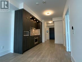 Toronto (Waterfront Communities) condo for rent - A modern kitchen with dark wood cabinets and a marble backsplash.