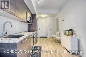 Toronto (Church-Yonge Corridor) condo for rent - A kitchen with a sink and a countertop with a microwave above it.