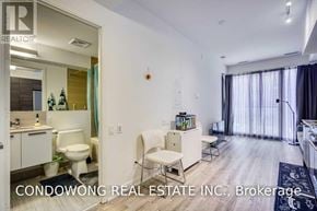 Toronto (Church-Yonge Corridor) condo for rent - A well-lit, spacious living room with a dining area and a bathroom visible in the background.