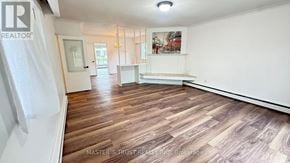 Toronto (Willowdale West) apartment for rent - A spacious room with wooden flooring and white walls.