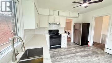 Toronto (Willowdale West) apartment for rent - A kitchen with a black oven and a black sink.