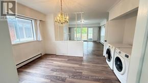 Toronto (Willowdale West) apartment for rent - A laundry room with a chandelier and a washer and dryer.