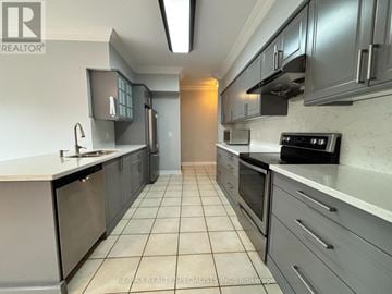 Brampton (Sandringham-Wellington) house for rent - A modern kitchen with grey cabinets and a white countertop.