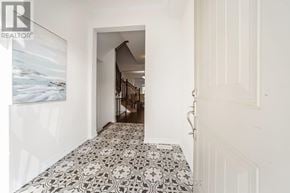 Vaughan (Kleinburg) apartment for rent - A hallway with a tile floor and a painting on the wall.