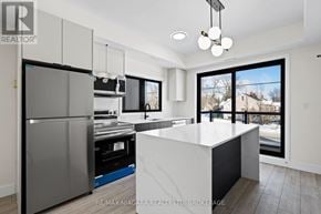 Niagara Falls (Oldfield) condo for rent - A modern kitchen with a large island and stainless steel appliances.