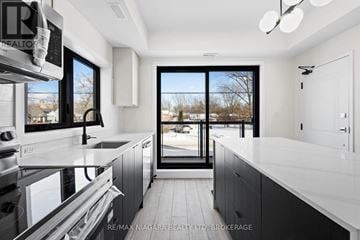 Niagara Falls (Oldfield) condo for rent - A modern kitchen with a stainless steel oven and black cabinets.