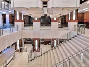 Markham (Unionville) condo for rent - A staircase in a building with a glass railing.