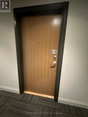 Milton (Fo Ford) condo for rent - A brown door with the number 213 on it.