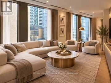 Toronto (Annex) condo for rent - A living room with a large sectional sofa and a coffee table in the center.